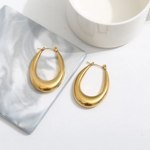 Minimalist 18k gold plated teardrop U-shape hoop earrings on a marble decor background