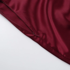 Macro detail of high-quality invisible zipper on the wine red satin backless dress
