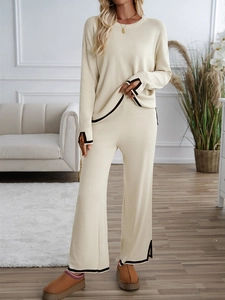 Beige knit two-piece set with round neck top, wide leg pants and black contrast trim