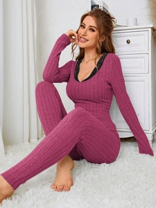 Close-up of ribbed knit texture and black lace neckline on dark pink loungewear set
