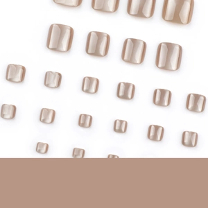 Brown cat-eye press-on toenails with sparkling pearlescent finish on white background