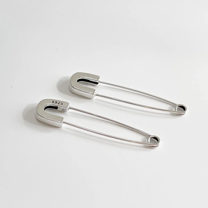 Minimalist 925 sterling silver safety pin earrings with a polished metallic finish