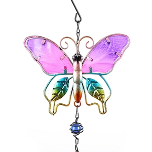 Detail of metal butterfly wind chime with pink and purple gradient glass wings