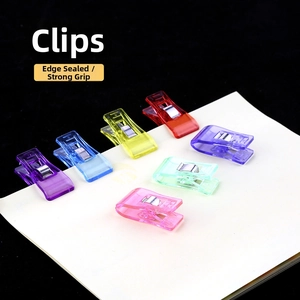 Close-up of colorful transparent heart-shaped clips for paper and fabric sewing