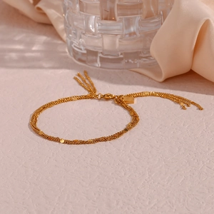 Detail of 18K gold-plated multi-layer chain with metal sequins and tassel fringes