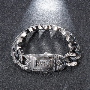 Macro shot of retro stainless steel bracelet with intricate vintage floral carvings