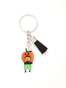 Detail view of Halloween acrylic keychain featuring cartoon pumpkin man and black tassel