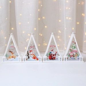 Detail of four white Christmas LED lanterns with festive reindeer and snowman patterns