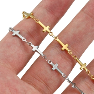 Polished 18K gold and silver stainless steel cross chain bracelets for women shown on wrist