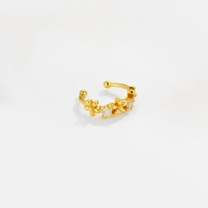 Detail of gold flower ear cuff with sparkling zircon stones and a minimalist design