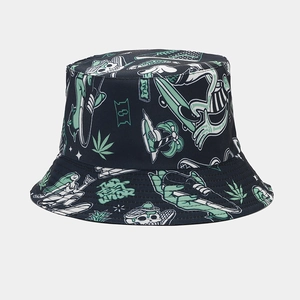Detail of black reversible bucket hat with street graffiti print and marijuana leaf motifs