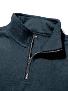 Detailed view of dark blue fleece fabric and half-zip stand collar with L size tag