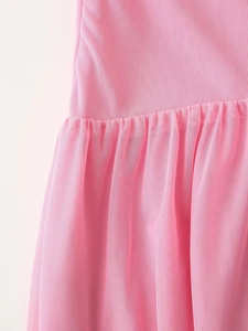 Detailed macro view of the pink mesh fabric texture and delicate pleated stitching