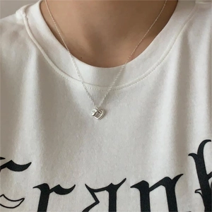 Minimalist 925 sterling silver heart necklace on model with refined silver chain