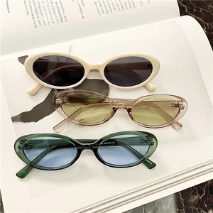 Flat lay of retro oval sunglasses in multiple colors on a minimalist magazine layout