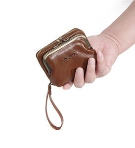 Brown litchi grain small zip wallet with wrist strap held in hand for size overview