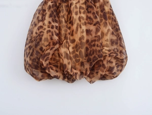Detailed view of leopard print texture with ruched fabric and bubble hem design