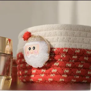Close-up of a red and white woven cotton basket featuring a plush Santa Claus ornament