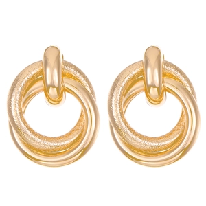 Close-up of gold layered hoop earrings with smooth and frosted twisted texture finish