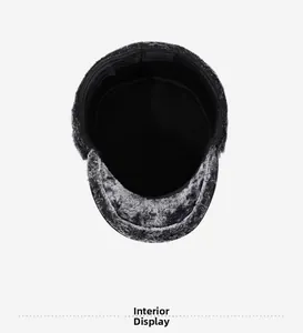 Detail view of the thick warm lining and gray faux fur trim on winter flat cap for men