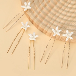 5-piece bridal hair pin set with white ceramic lilies and gold wavy metal stems