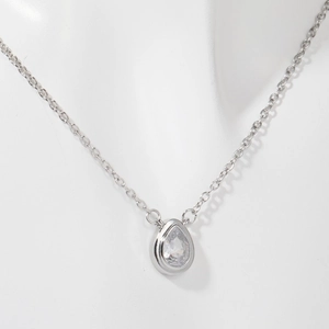 Close-up of pear-shaped clear zircon pendant necklace on white mannequin bust