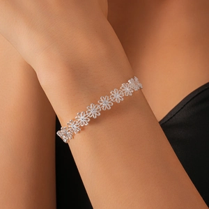 Detail of silver hollow daisy flower bracelet on wrist with elegant metallic finish