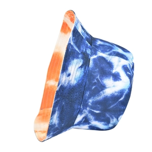 Detail of reversible tie-dye bucket hat showing blue and orange marble patterns