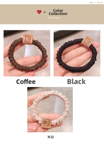 Detailed shot of elastic scrunchies in brown, black, and beige with cute bear tags