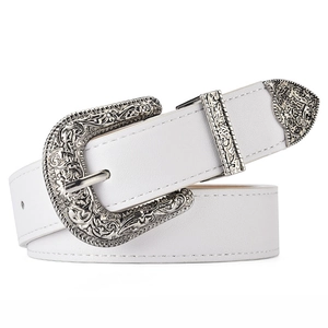 Detail of white faux leather western belt with ornate engraved silver buckle and tip