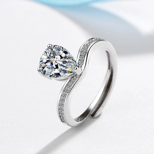 Adjustable silver ring with water drop zircon and small diamonds on white textured background