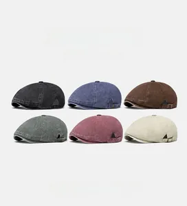 Multiple colors of vintage washed cotton newsboy caps with side metal buckles