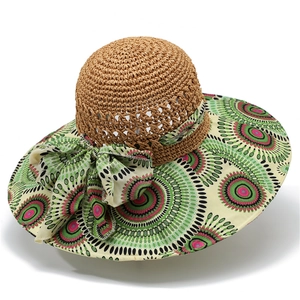 Detail of hand-woven straw hat texture with a vibrant bohemian floral silk ribbon bow
