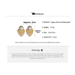 Detailed view of fan-shaped drop earrings with large pearls and sparkling zircons