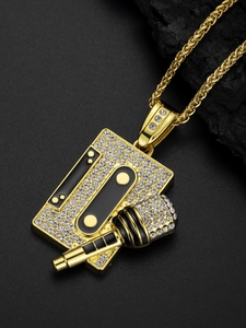 Detailed close-up of iced-out gold hip hop necklace featuring a tape and microphone pendant