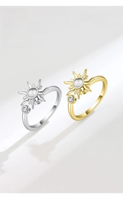Detail of silver and gold spinning sunflower rings with moonstone and zircons