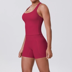 Detail of red athletic yoga set featuring side pocket shorts and racerback crop top