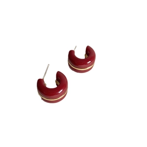 Vintage burgundy C-shaped enamel earrings with gold waist line on white background