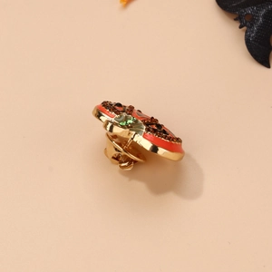 Detail of Halloween pumpkin brooch with orange enamel and sparkling black crystal eyes