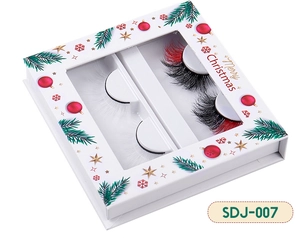 Detail of Christmas themed white and mixed color mink lashes in a festive gift box