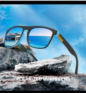 Close-up of polarized sunglasses on beach rocks showing UV400 blue mirrored lens reflections