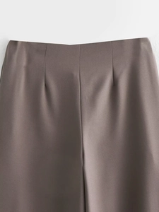 Detailed close-up of dark taupe dress pants showing high waist dart and premium fabric