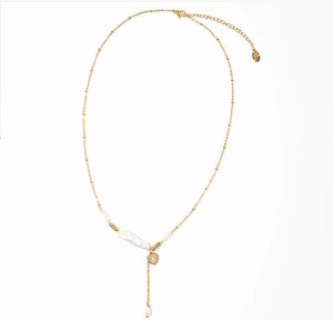 Detailed view of baroque pearl necklace with gold heart pendant and Y-shaped chain design