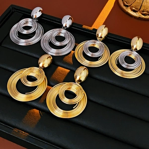 Macro view of multi-layered spiral metal earrings in gold and silver finishes