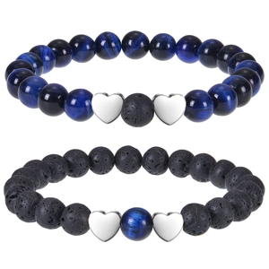 Detail of tiger eye and lava stone beads on stretch bracelets with heart charms