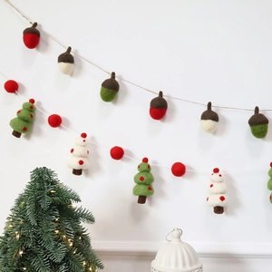 Handmade wool felt Christmas tree and acorn garland ornaments for festive wall decoration
