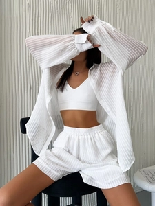 Detail of white three-piece leisure set showing textured stripe fabric and light material