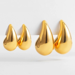 Detail view of two pairs of 18K gold-plated stainless steel teardrop earrings on white