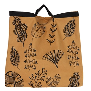 Detailed view of yellow canvas tote bag featuring black leaf illustrations and handles