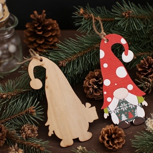 Christmas wooden forest gnome hangers with red polka dot hat on pine needles background